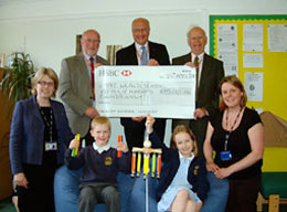 Photo of cheque presentation for £1500 to local school