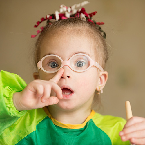 Photo of little girl pointing at her nose